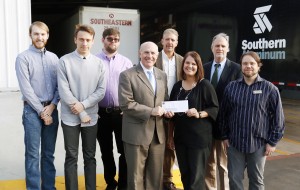 SAU President Dr. Trey Berry accepts a $5,000 check from Amanda Blanchard of Southern Aluminum. Pictured, from left, are SAU Art and Design students employed by Southern Aluminum Andrew Hinkle, Zach Miller, and Morgan Daniel, Berry, Chair of the Department of Art and Design Steven Ochs, Blanchard, Interim Provost and VPAA Dr. Ben Johnson, and Assistant Professor of Graphic Design Shawn Latham.