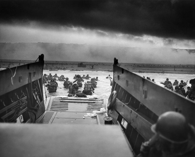 U.S. troops wading ashore from a landing craft at Omaha Beach, Normandy, on D-Day, June 6, 1944